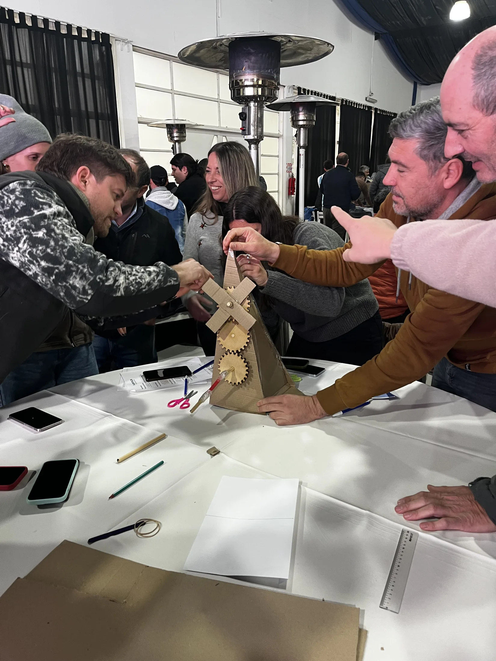 Equipo construyendo un molino de cartón durante una dinámica de liderazgo